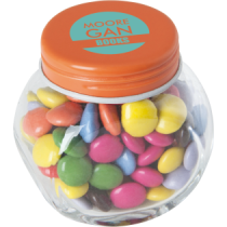 Kleine glazen pot gevuld met ca. 40 gr. choco carletties gekleurd deksel